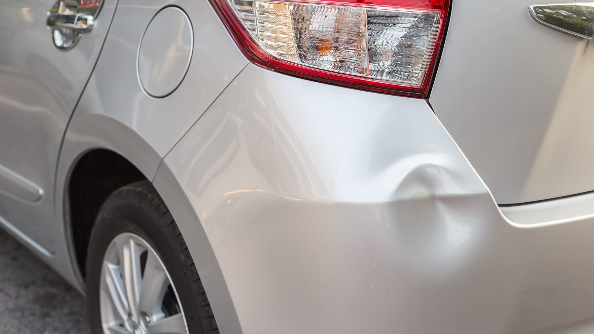 Backside of new silver car get damaged by accident