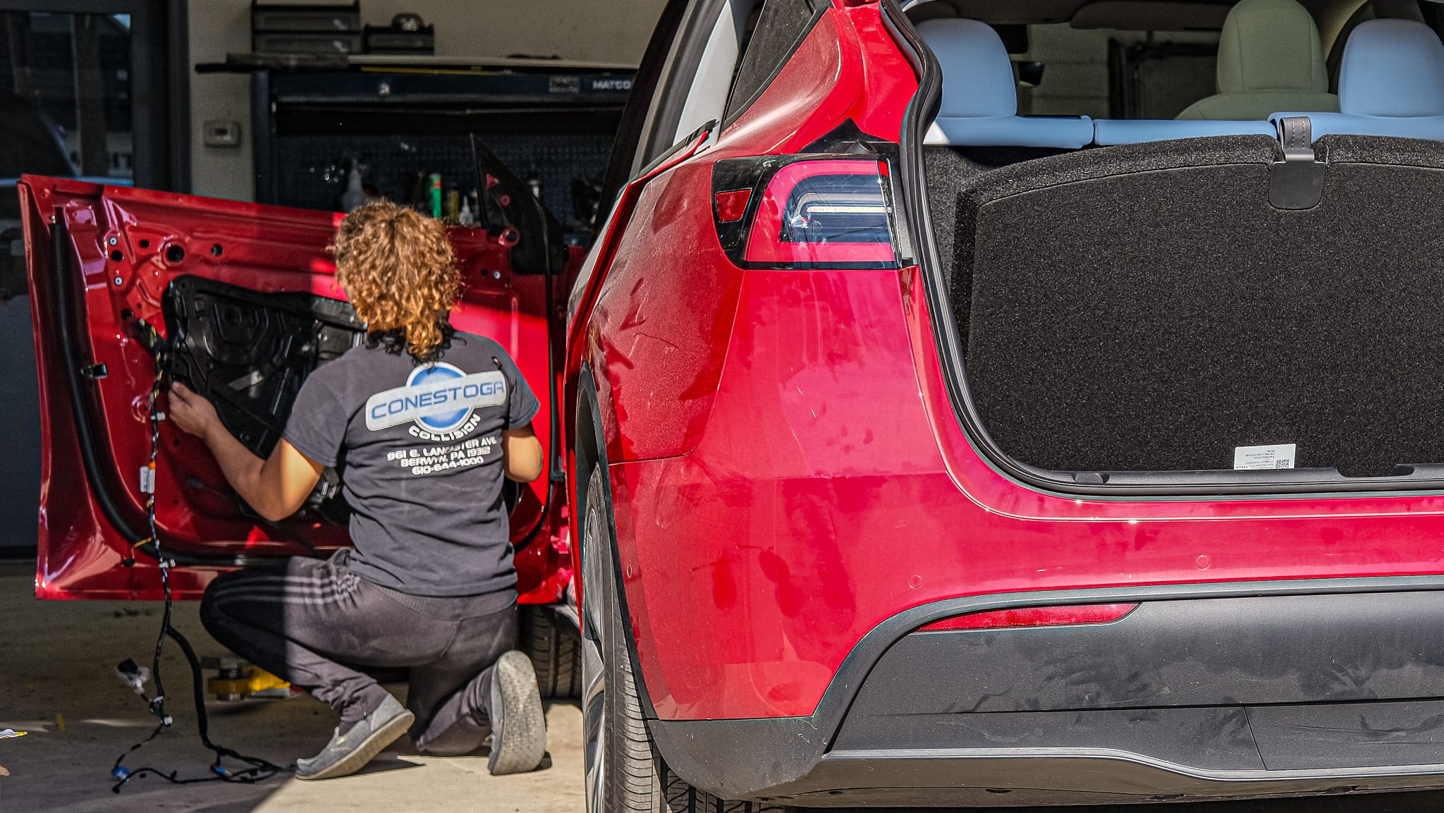 Technician Sydney disassembling a Tesla, cataloging every part along the way. 