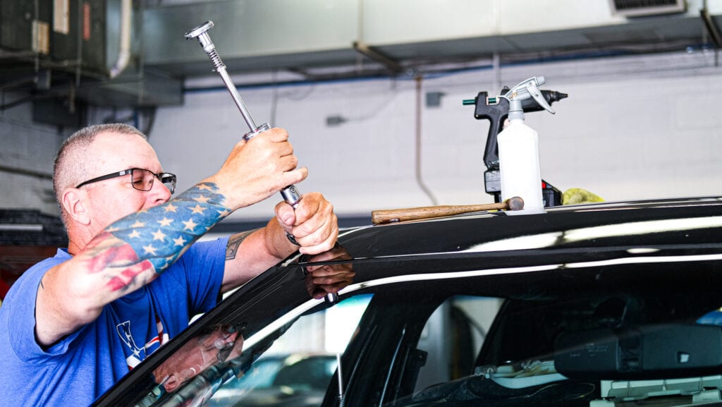 DSCF3485 Conestoga Collision technician using paintless dent repair techniques.